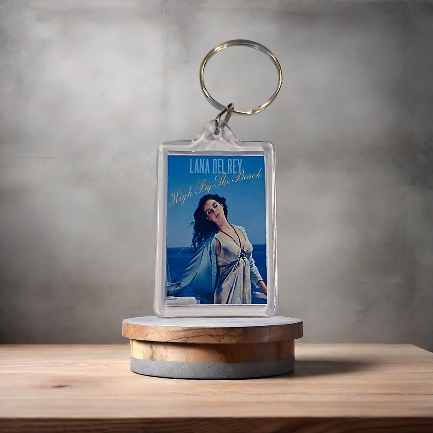 Lana Del Rey High by the Beach poster keychain with metal prints encased. Plenty to choose from