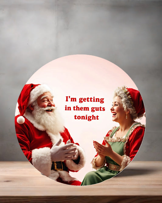 Christmas ornament , 3" round ceramic. Adult themed Santa's getting in them guts